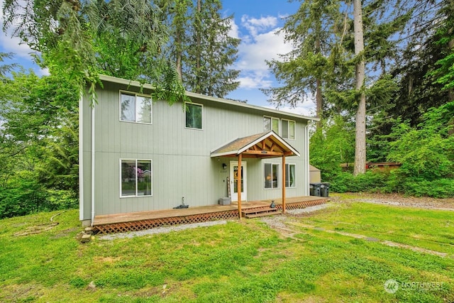 view of front of house with a wooden deck and a front yard