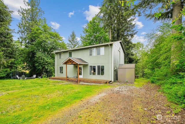 view of front property featuring a shed, a trampoline, and a front lawn