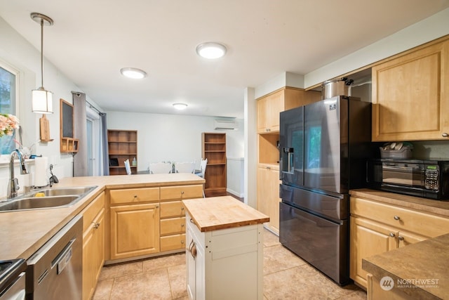 kitchen with stainless steel appliances, sink, decorative light fixtures, a center island, and butcher block countertops