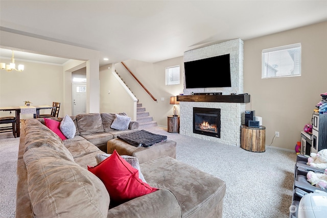 living room featuring a fireplace, carpet floors, and an inviting chandelier