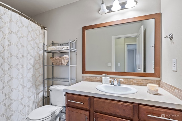 bathroom with decorative backsplash, vanity, and toilet