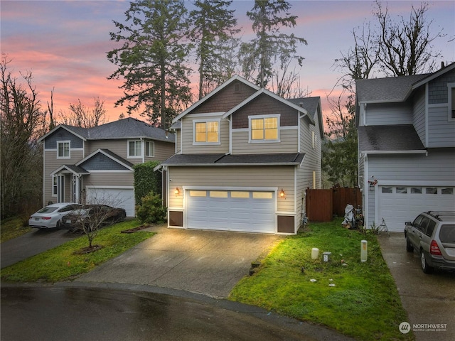 view of front of home featuring a garage and a yard