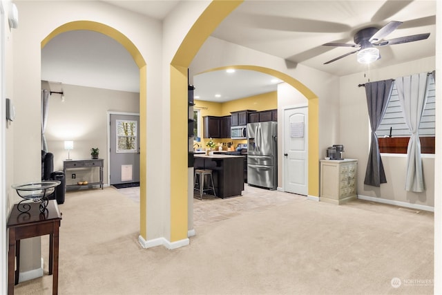 interior space with ceiling fan