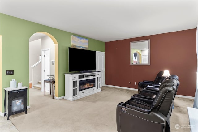 living room featuring a fireplace and light colored carpet