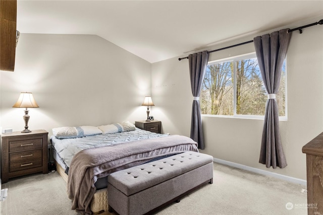 carpeted bedroom with lofted ceiling