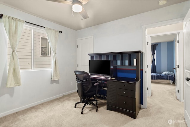 home office with light carpet and ceiling fan