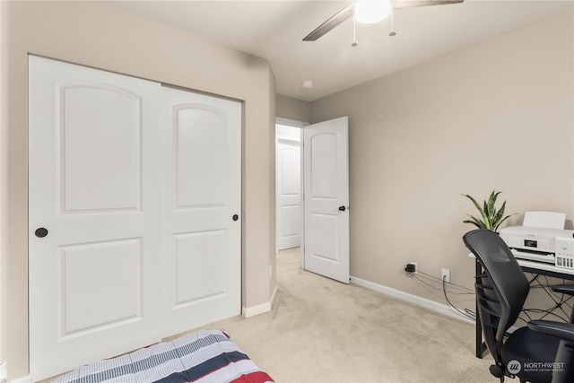 office space featuring ceiling fan and light carpet