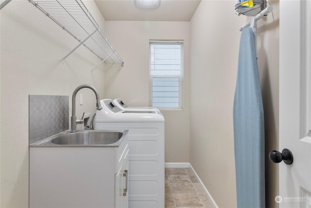 washroom with washing machine and dryer and sink