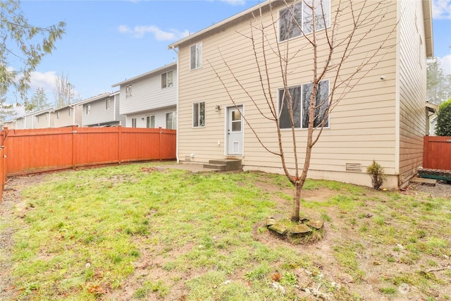 rear view of house with a yard