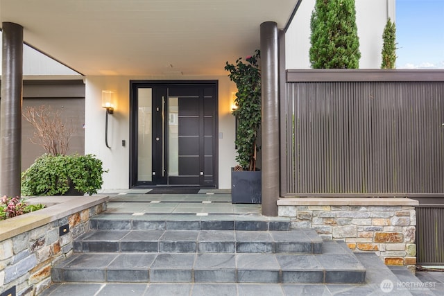 property entrance featuring stone siding