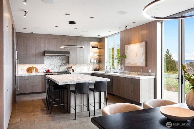 kitchen featuring light countertops, modern cabinets, open shelves, and decorative light fixtures