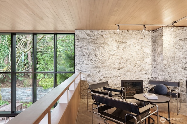 balcony featuring a glass covered fireplace