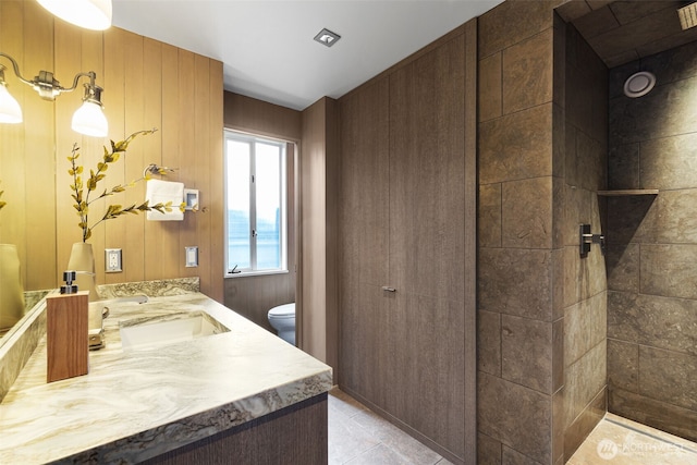 bathroom featuring toilet, tile patterned flooring, and vanity