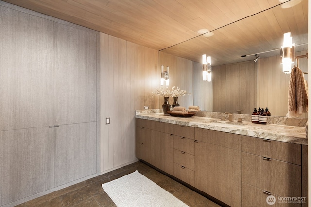 bathroom featuring vanity, wood ceiling, and wooden walls