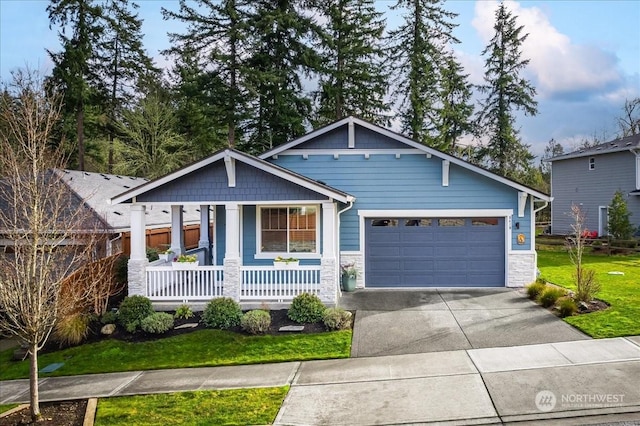 craftsman-style house featuring a front yard, a porch, and a garage