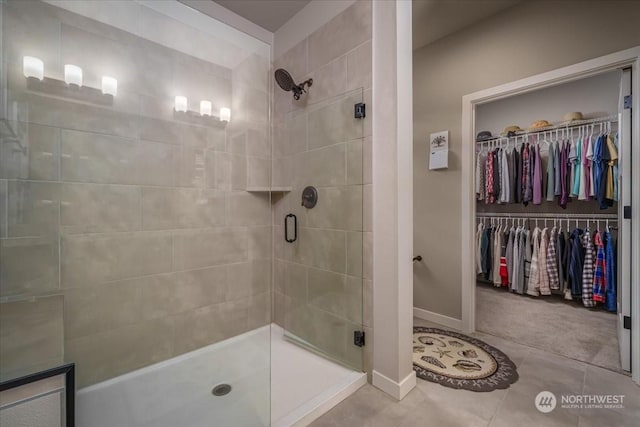 bathroom with an enclosed shower and tile patterned flooring