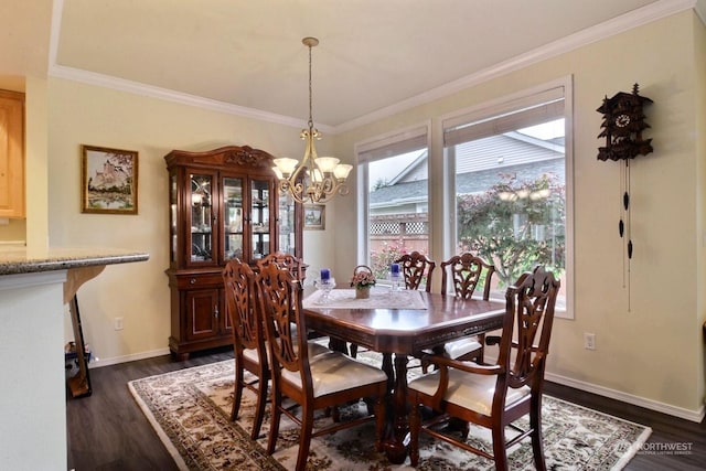 dining area with dark hardwood / wood-style floors, crown molding, and an inviting chandelier