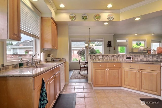 kitchen with dishwasher, an inviting chandelier, sink, light tile patterned floors, and decorative light fixtures