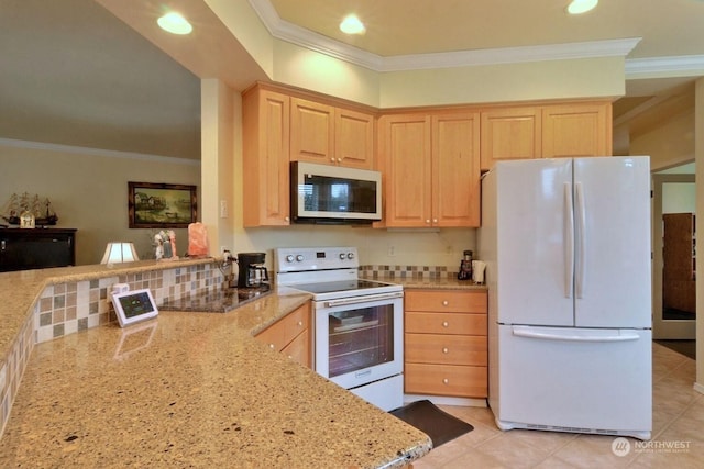 kitchen featuring white appliances, decorative backsplash, light brown cabinetry, light stone counters, and kitchen peninsula