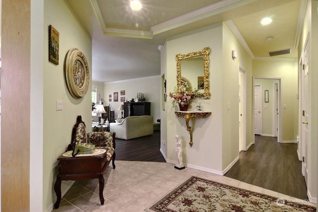 hall with tile patterned flooring and crown molding