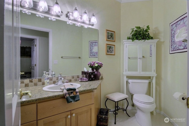 bathroom with tile patterned flooring, vanity, and toilet