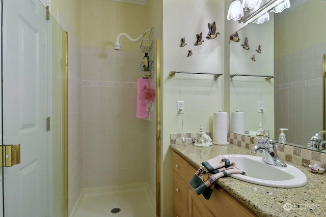 bathroom featuring vanity and a shower with shower door