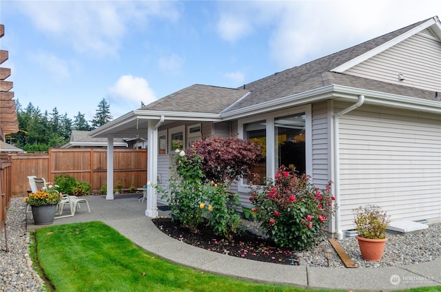 exterior space featuring a patio area and a lawn