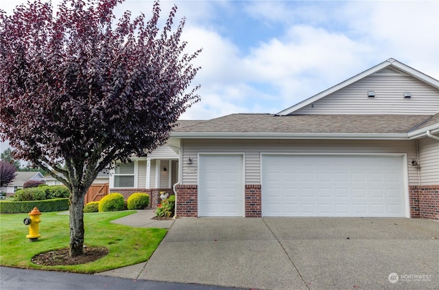 ranch-style house featuring a garage and a front yard