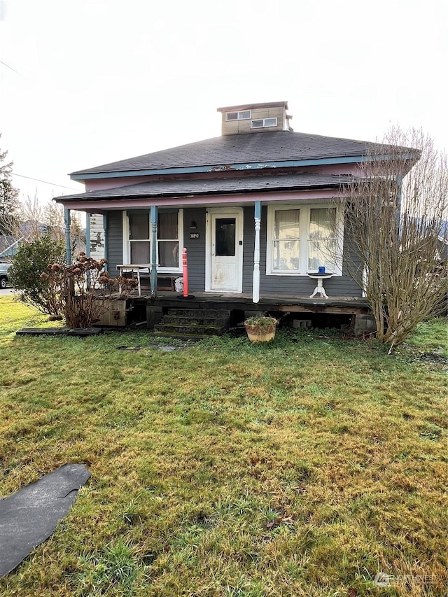 view of front of house with covered porch and a front yard