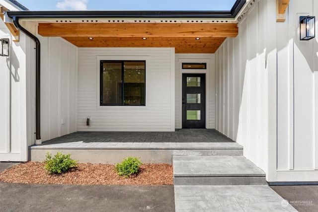 view of exterior entry with a porch