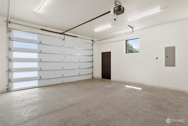 garage with a garage door opener and electric panel