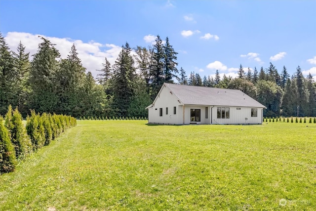 rear view of house with a yard