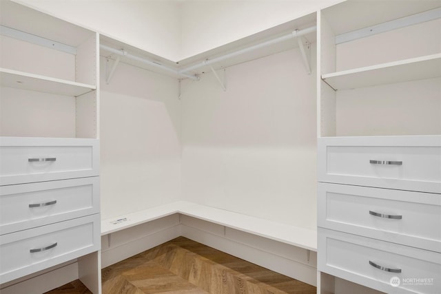 walk in closet featuring parquet floors