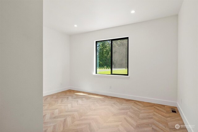 unfurnished room with light parquet floors