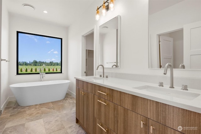 bathroom with vanity and a bath