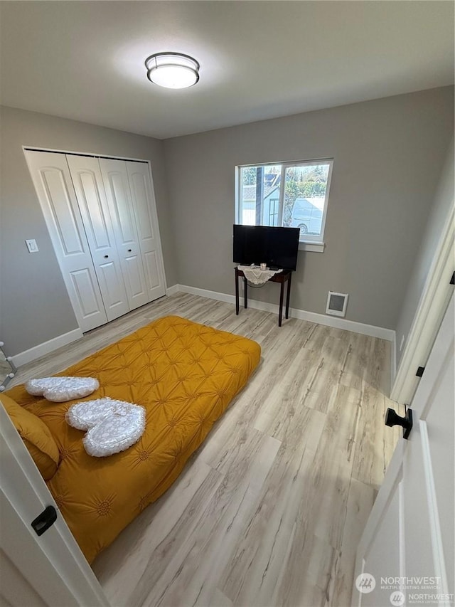 bedroom featuring a closet and light hardwood / wood-style floors