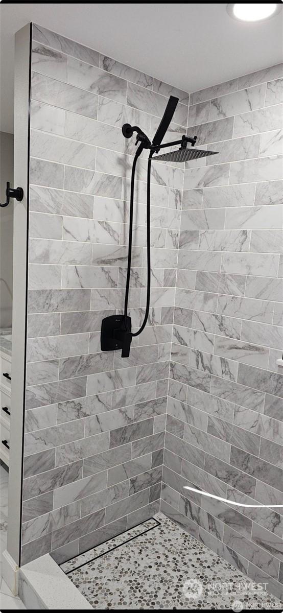 bathroom with a tile shower