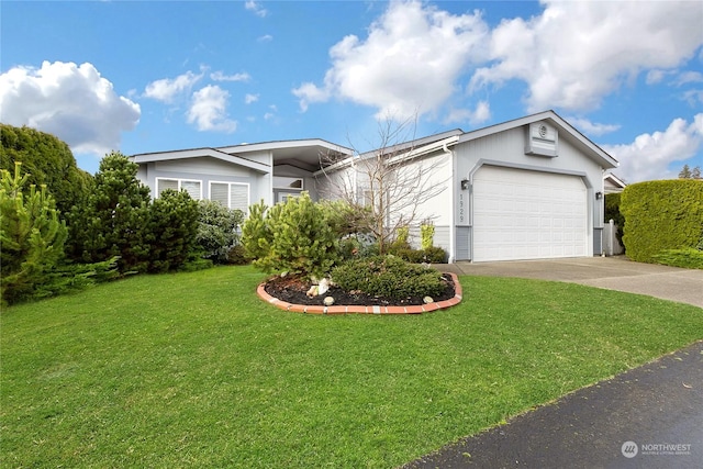 view of front facade with a front yard and a garage