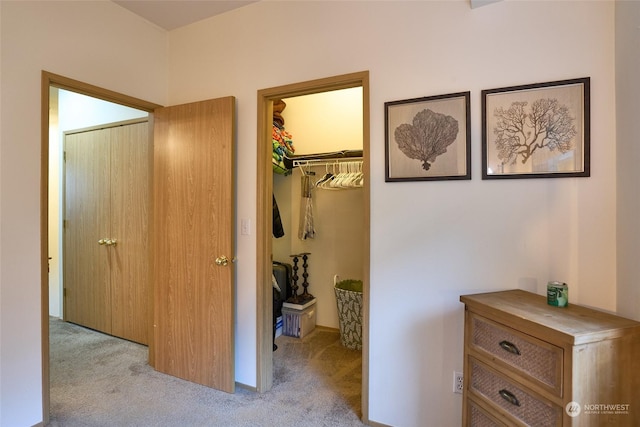 hallway featuring light carpet