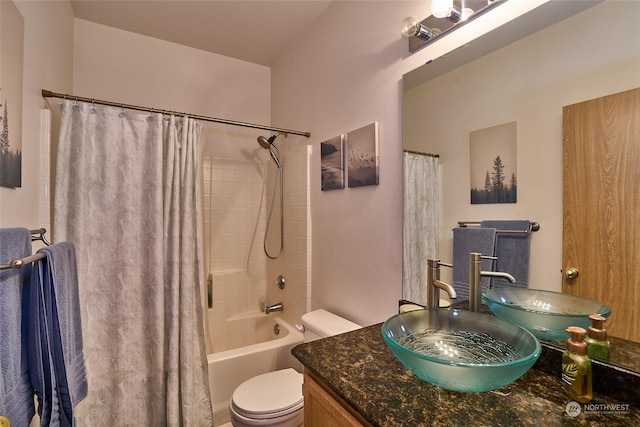 full bathroom with toilet, shower / bathtub combination with curtain, and sink