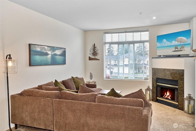 carpeted living room with a tile fireplace