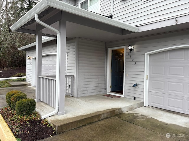 view of exterior entry with a garage