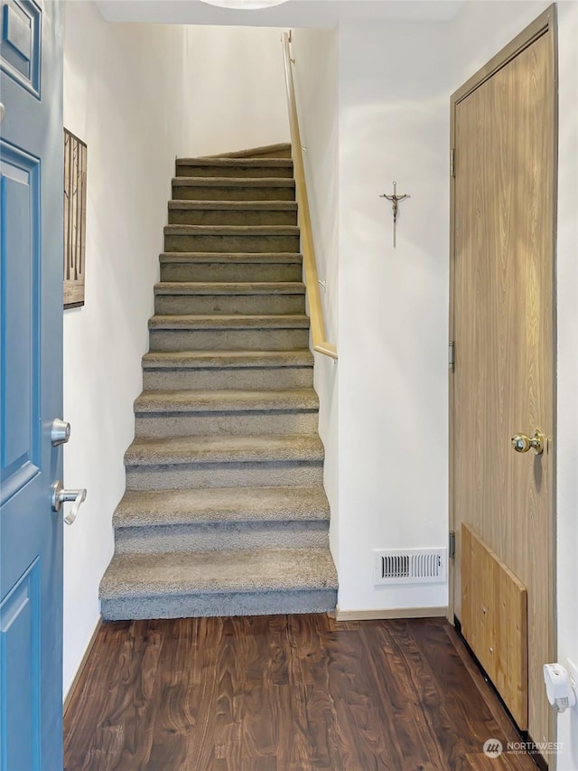 staircase featuring hardwood / wood-style flooring