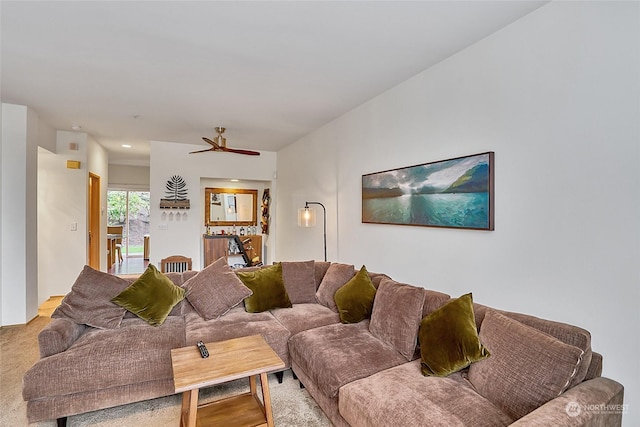 carpeted living room featuring ceiling fan