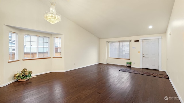 entrance foyer featuring a chandelier, vaulted ceiling, and dark wood-type flooring