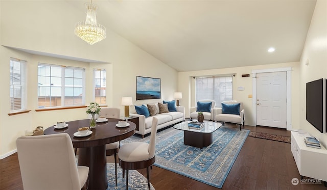 living room featuring dark hardwood / wood-style flooring, high vaulted ceiling, and an inviting chandelier