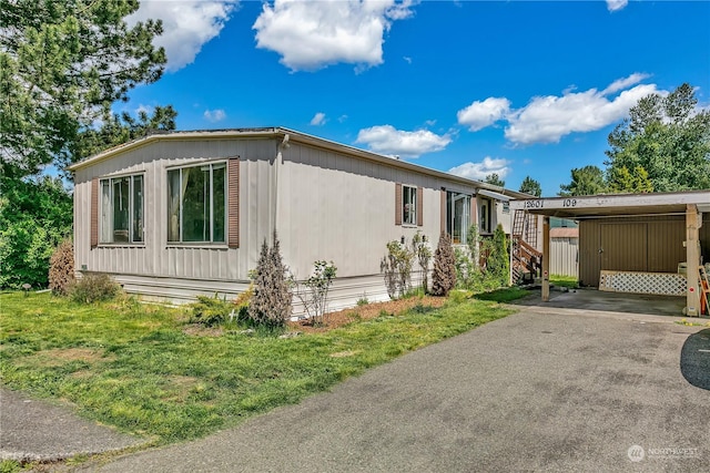 view of property exterior featuring a carport and a yard