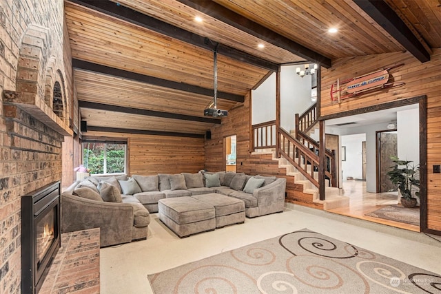 living room with lofted ceiling with beams, wood walls, wood ceiling, and a fireplace