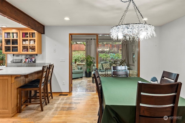 dining room featuring a chandelier and beam ceiling