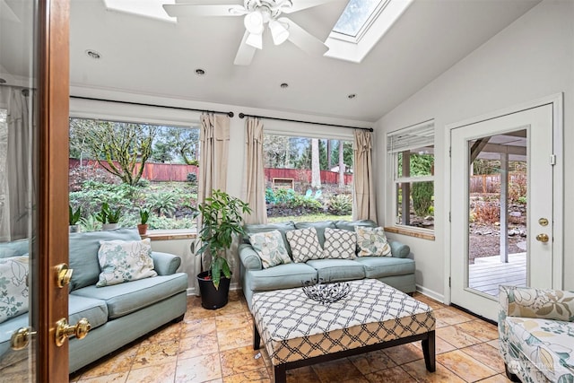 sunroom with ceiling fan, a healthy amount of sunlight, and lofted ceiling with skylight